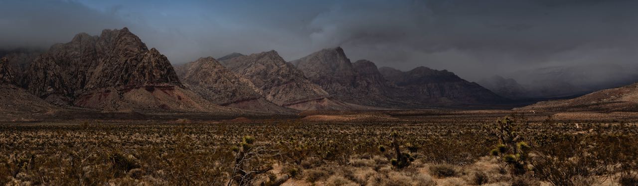 Desert mountain range under a stormy sky